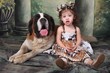 Adorable Child and Her Saint Bernard Puppy Dog