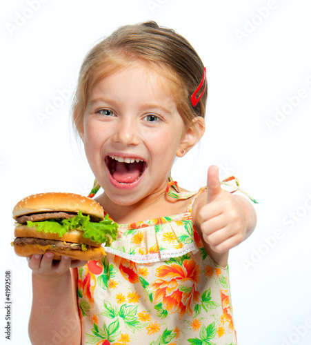 Photo: little girl eating a sandwich isolated little girl eating a sandwich isolated