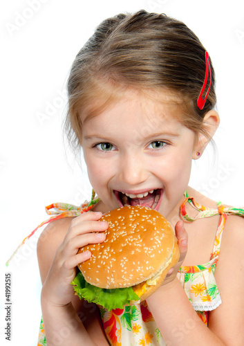 Foto: little girl eating a sandwich isolated little girl eating a sandwich isolated
