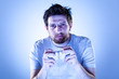 Serious Man Playing Videogames with Gamepad