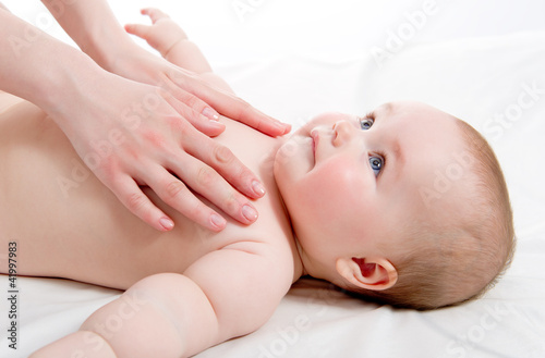 Foto: Mother massaging her lovely baby Mother massaging her lovely baby