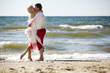 Bride and groom kissing on the beach