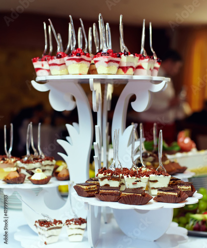 Photo: many servings of sweet tasty dessert on buffet many servings of sweet tasty dessert on buffet