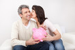 Foto: Mature couple saving money in piggybank Mature couple saving money in piggybank