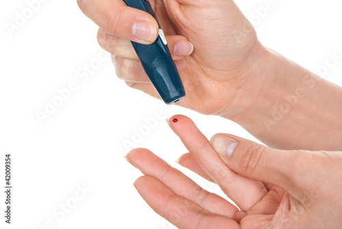 Photo: Diabetes lancet in hand prick finger small blood Diabetes lancet in hand prick finger small blood
