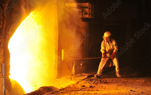 Photo: worker takes a sample at steel company worker takes a sample at steel company