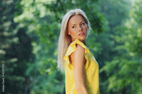 Photo: Beautiful Healthy Woman over Nature background Beautiful Healthy Woman over Nature background