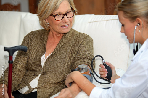 Photo: Doctor taking blood pressure Doctor taking blood pressure