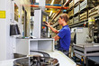 skilled worker controlling a digitally programmed machine tool