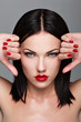 Portrait of  woman with make-up and red bright manicure