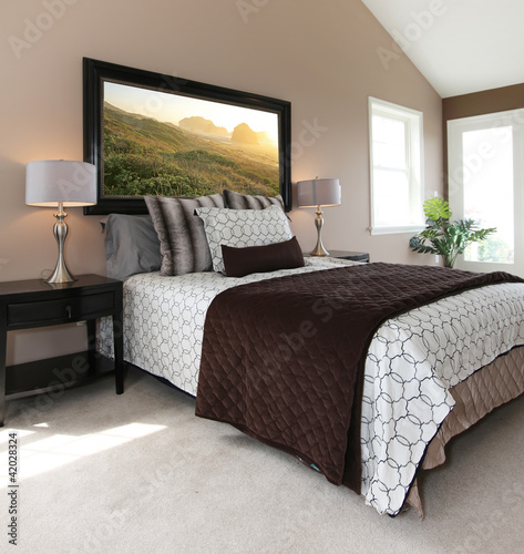 Photo: Modern brown and white bed with nightstands. Modern brown and white bed with nightstands.
