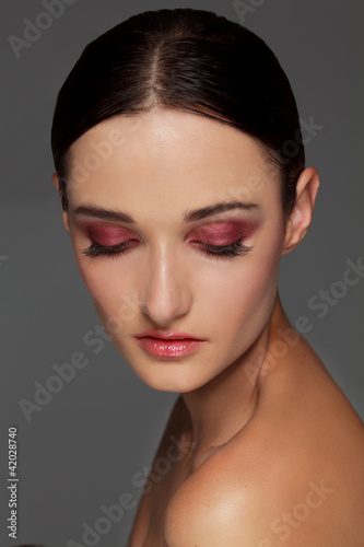 Photo: Close-up portrait of beautiful young woman's face Close-up portrait of beautiful young woman's face
