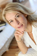 Portrait of blond mature woman relaxing in sofa