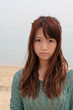 A young woman at beach / Long hair