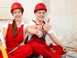Worker in a building lot fixing up a house show thumbs up