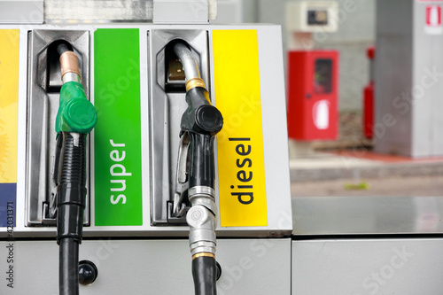 Photo: gasoline pump nozzles at petrol station gasoline pump nozzles at petrol station