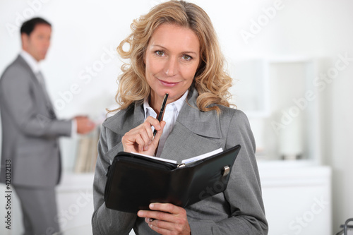 Foto: Blond woman with book in hand Blond woman with book in hand