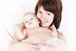 Happy mother and daughter lying on the bed