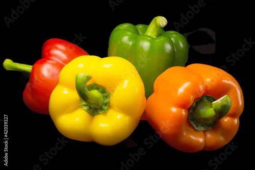Photo: Color peppers on a black background. Color peppers on a black background.