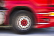 A fast moving truck passes by with motion blur.