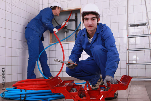 Photo: Plumbing team with a toolbox Plumbing team with a toolbox