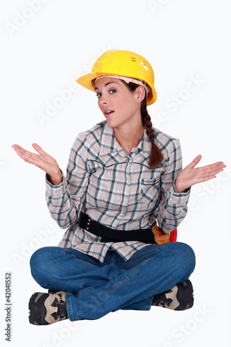 Photo: Handywoman sitting, studio shot Handywoman sitting, studio shot