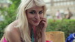 Portrait of beautiful happy blonde woman in the city