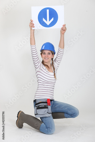 Photo: Woman holding road sign Woman holding road sign