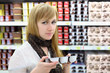 Foto: Blonde girl wearing scarf chooses yoghurt in store Blonde girl wearing scarf chooses yoghurt in store