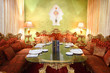 beautiful glass table with serving and red sofas