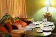 beautiful glass table with serving, lamp and sofa