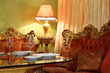 beautiful table with serving, lamp and carved sofa