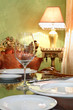 glass and white plates at table in cozy restaurant