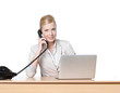 Young business woman sitting at a table with phone handset