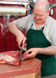 Photo: Butcher cutting steaks Butcher cutting steaks
