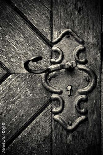 Photo: Retro keyhole in old wooden door Retro keyhole in old wooden door