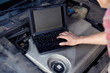 Car mechanic with laptop