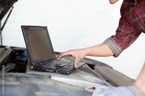 Photo: Car mechanic with laptop Car mechanic with laptop