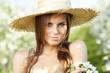 beautiful young woman standing near the apple tree on a warm sum