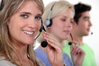Woman and colleagues wearing headsets