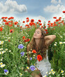 Angel on vacation in a field with spring flowers