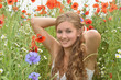 Angel on vacation in a field with spring flowers