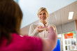Photo: girl returning book to librarian in library girl returning book to librarian in library