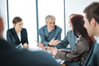 Photo: Portrait of a positive manager with his team sitting Portrait of a positive manager with his team sitting