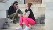 Two fashion young woman talking on stairs