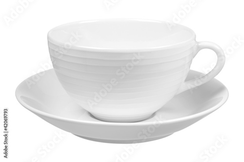 Photo: Clear white cup on plate isolated on white background Clear white cup on plate isolated on white background
