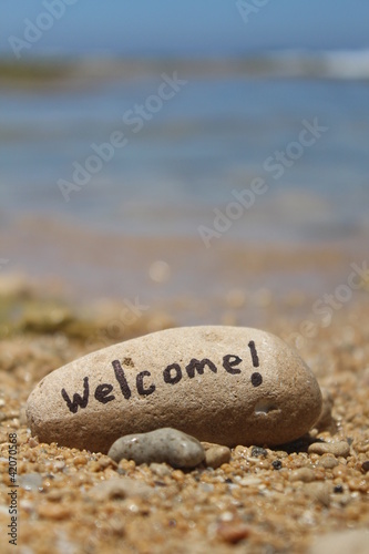 Photo: Welcome! - Written on a rock, at the beach Welcome! - Written on a rock, at the beach