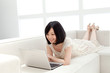Beautiful young woman using a laptop computer. Portrait of asian
