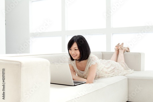 Photo: Beautiful young woman using a laptop computer Beautiful young woman using a laptop computer