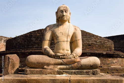 Foto: Ancient Buddha statue with blue sky on background Ancient Buddha statue with blue sky on background